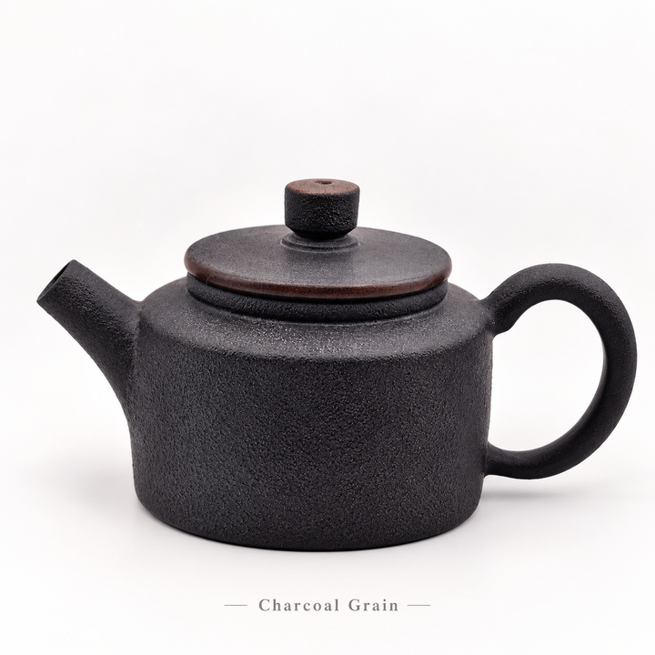 Charcoal Grain #11, cleaned front view of the 80 ml Jianshui Little Drum teapot, with subtitle